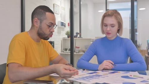 Business Meeting Analyzing Charts in Modern Office