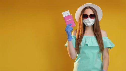 Young Woman with Passport Wearing Face Mask and Gloves