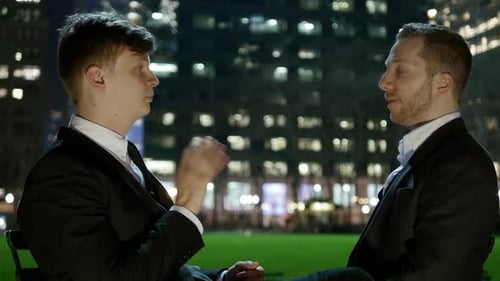 Two Young Business Coworkers Talking Together Working in Finance Career Job