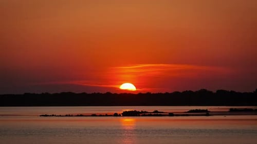 Vibrant Sunset Over Calm Water at Golden Hour