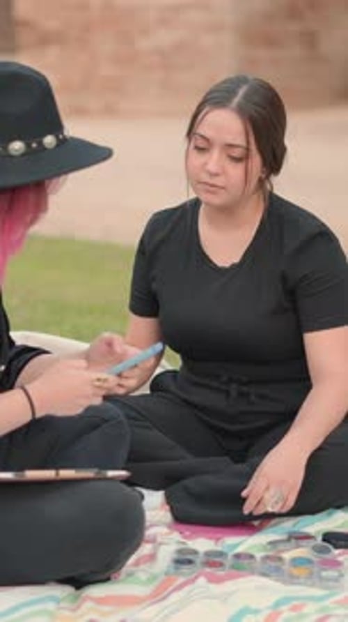 Young Adults with Palettes on Blanket