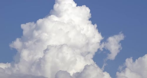 Fluffy Clouds Moving Slowly Across a Blue Sky