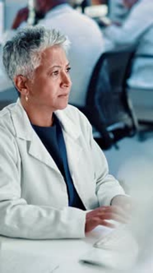 Woman Typing at Computer in Medical Office
