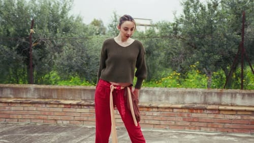 Woman Performing Elegant Dance Moves Outdoors