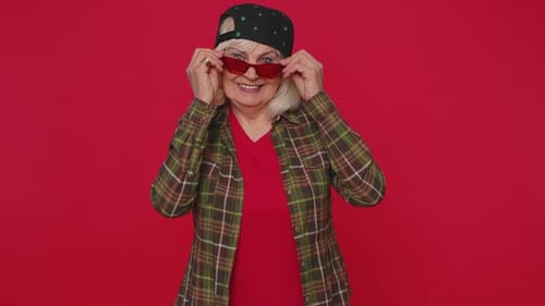 Smiling Senior Woman Wearing Cap and Sunglasses