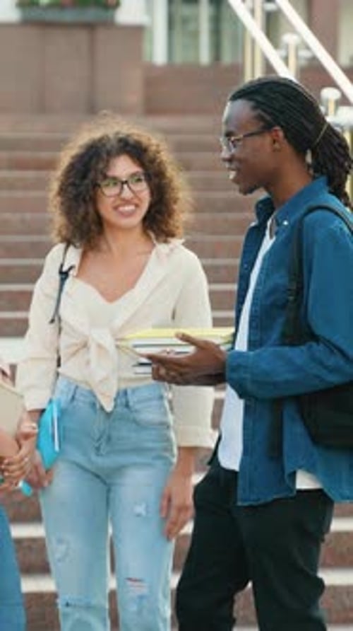 Diverse University Students Socializing and Discussing on Campus Stairs