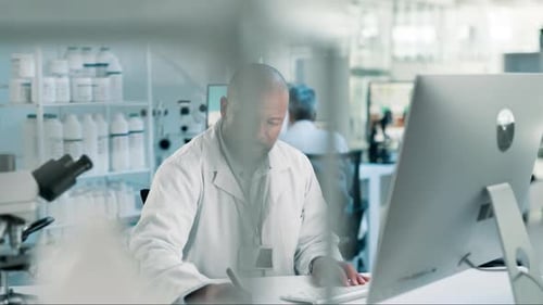 Scientist Working at Computer in Modern Laboratory