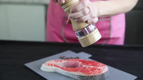 chef prepares a salmon dish in the kitchen. Close-up shots