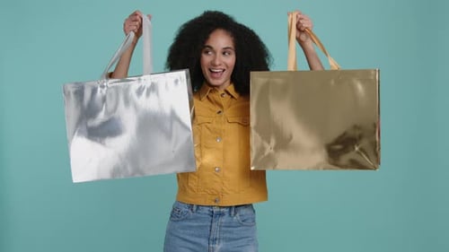 Woman Smiling and Holding Shopping Bags