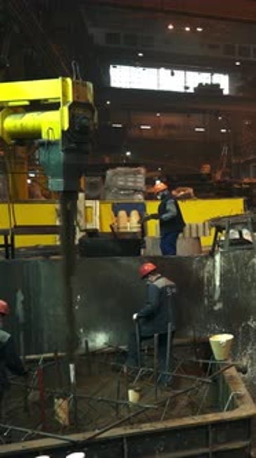 Foundry Workers Pouring Molten Metal in a Mold Stock Clip