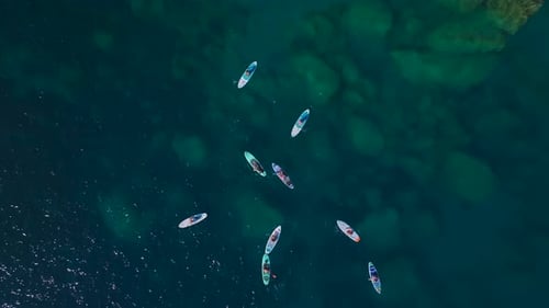 Aerial View Magical Beach Day With Crystal Waters People Swimming and Paddleboarding