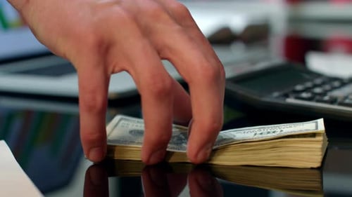 Stack of United States Currency on a Desk