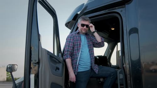 Confident Man Poses in Semi-Truck Cab Doorway