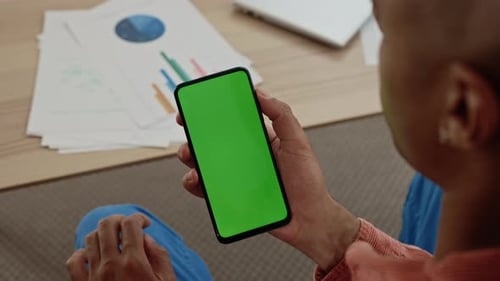 Hands of Multi Ethnic Businessman Using Smartphone with Green Screen for Financial Analysis