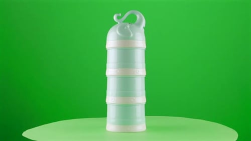Baby formula milk dispenser dosis dosifier elephant shape in a turntable with green screen for backg