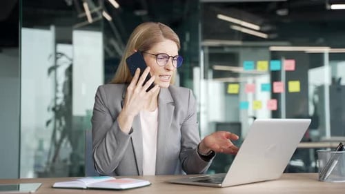 Frustrated Woman Arguing on Phone at Desk