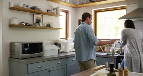 Couple Cooking and Laughing Together in Kitchen
