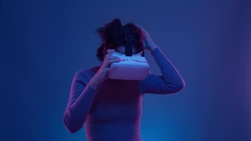 Woman smiles after VR experience in blue setting