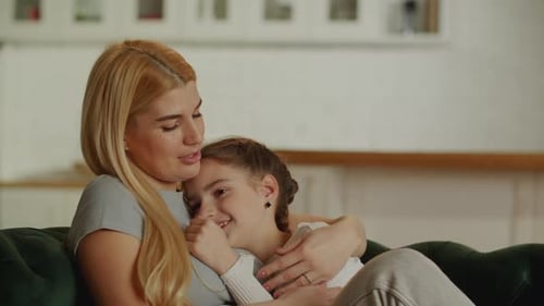 Affectionate Mother and Child Embracing on a Couch