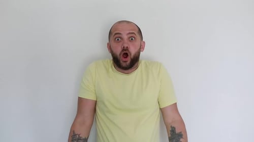 Bearded Man Reacts with Astonishment and Delight