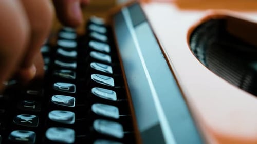 Writing letters with orange retro vintage typewriter