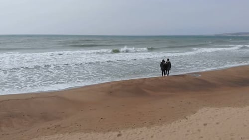 Young romantic Couple Walking On A Sandy Beach In Winter.Love,affection,nature