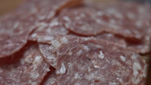 Heart Shapes of Fresh Italian Sliced Salami Sausage on a Wooden Tray Table
