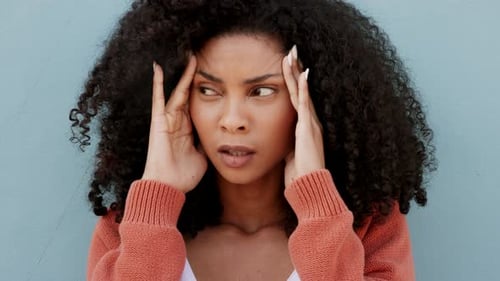 Woman Holds Head in Stress