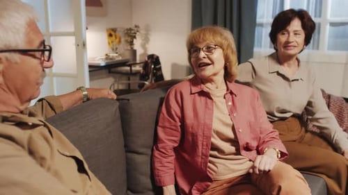 Three Mature Adults Chatting on a Sofa