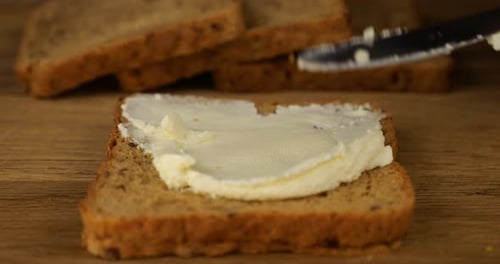 Spreading Butter on Multigrain Bread Slice