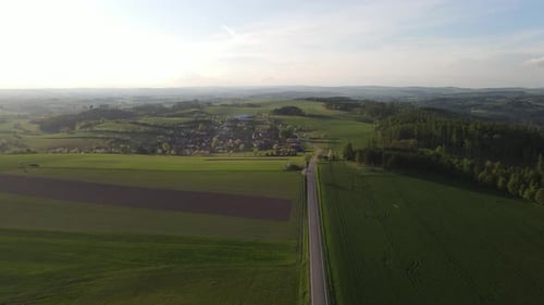 Drone footage of the road and village. Scenic 4k view of fields and road.