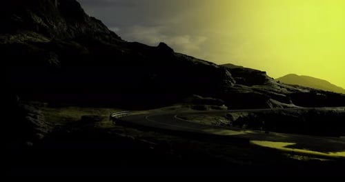 Majestic Mountain Road at Twilight with Dramatic Yellow Sky