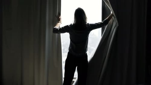 Woman Unveil Curtain And Admire View From Window At Home