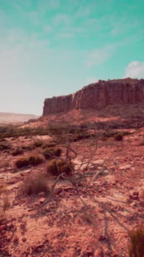 Stark Desert Landscape With Prominent Rock Formation
