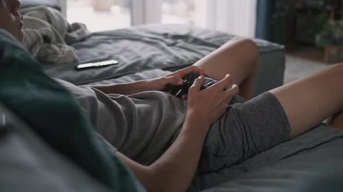 Young Adult Relaxing and Playing Video Game