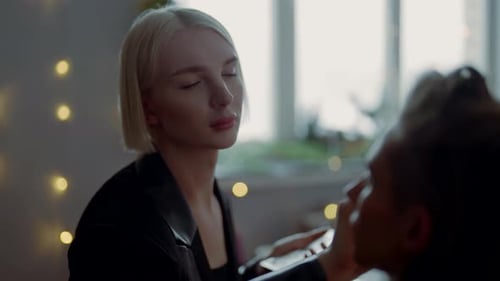 Makeup Artist Applying Cosmetics for Flawless Look