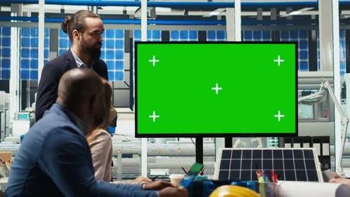Photovoltaics Plant Researchers Evaluating Energy Production on Mockup Monitor