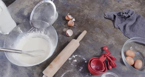 Close up of flour, milk and eggs on worktop in kitchen, slow motion