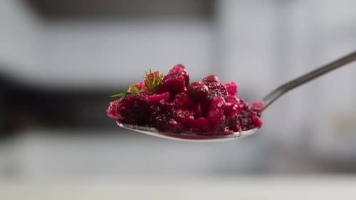 Russian Beetroot Vinaigrette Salad with Green Peas Boiled Vegetables and Dill Close Up in Restaurant
