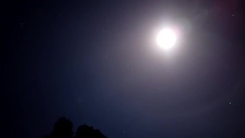 Radiant Moon Shines in Starry Night Sky