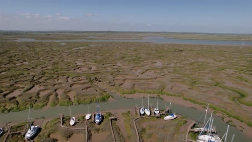 Boats In The Woodrolfe Creek Near The Tollesbury Fleet On A Sunny Day In Maldon, Essex, UK. - aerial