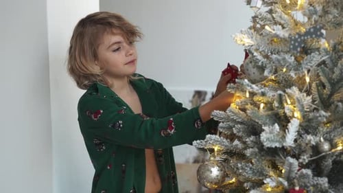 Young Girl Decorating Christmas Tree in Home Interior