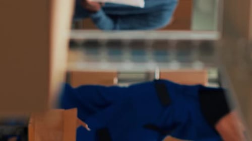 Vertical Video Male Owner Putting Goods in Cardboard Boxes From Shelves