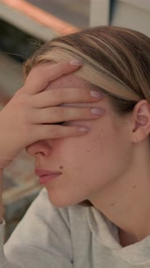 Tired Young Woman with Hand on Head