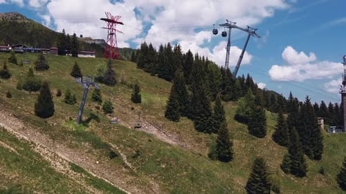 Cable car installation filmed by drone, from the distance. Shot captured in a beautiful summer day,