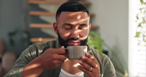 Man Enjoying a Refreshing Drink Indoors, Close-Up