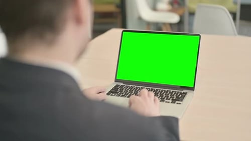 Businessman Working on Laptop with Green Screen