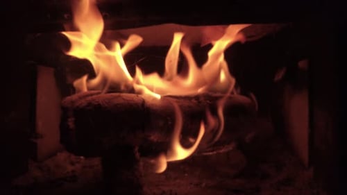 Glowing Fireplace with Burning Flames and Logs