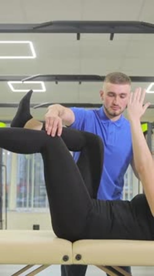 Physical Therapist Assisting Patient with Leg Stretch