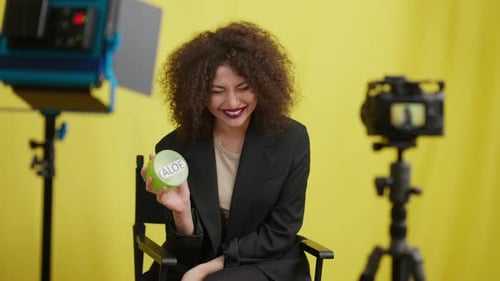 Woman Promoting Beauty Product in Studio Setting